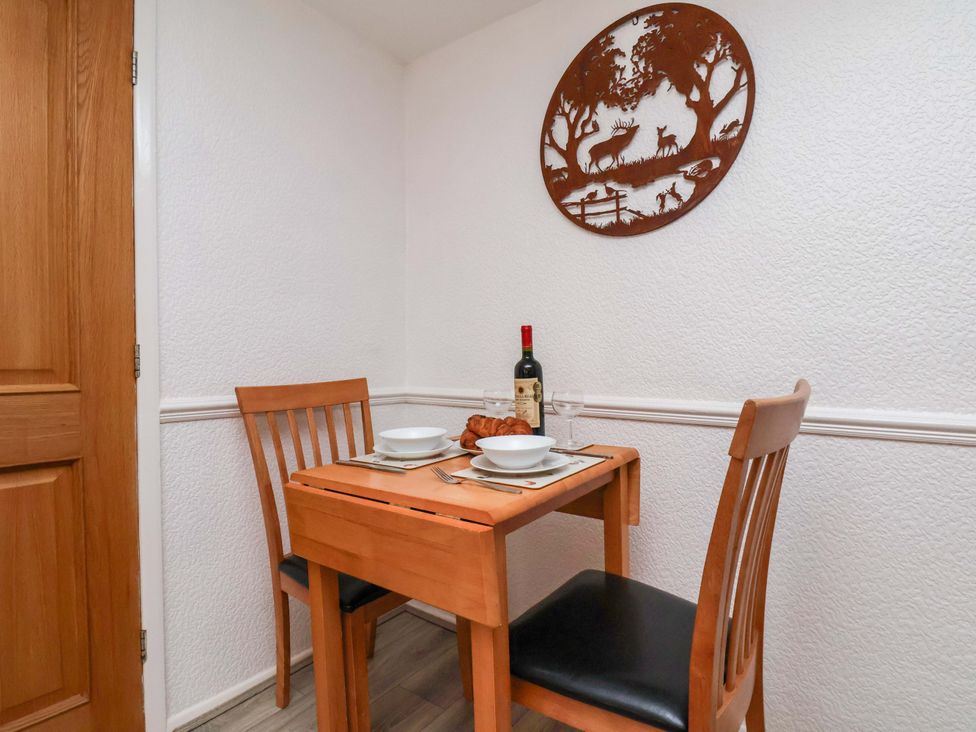 A dining area with a table and chairs at Wayside Farm Dairy Cottage in Cloughton near Burniston