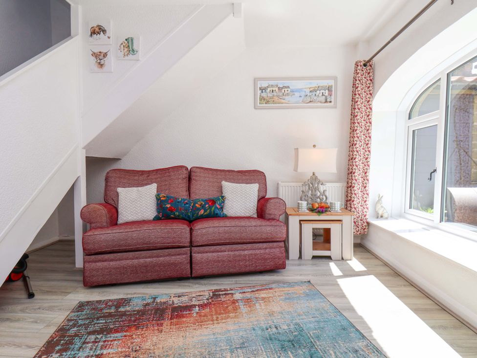A living room with a sofa and side table at Wayside Farm Stable Cottage Cloughton near Burniston