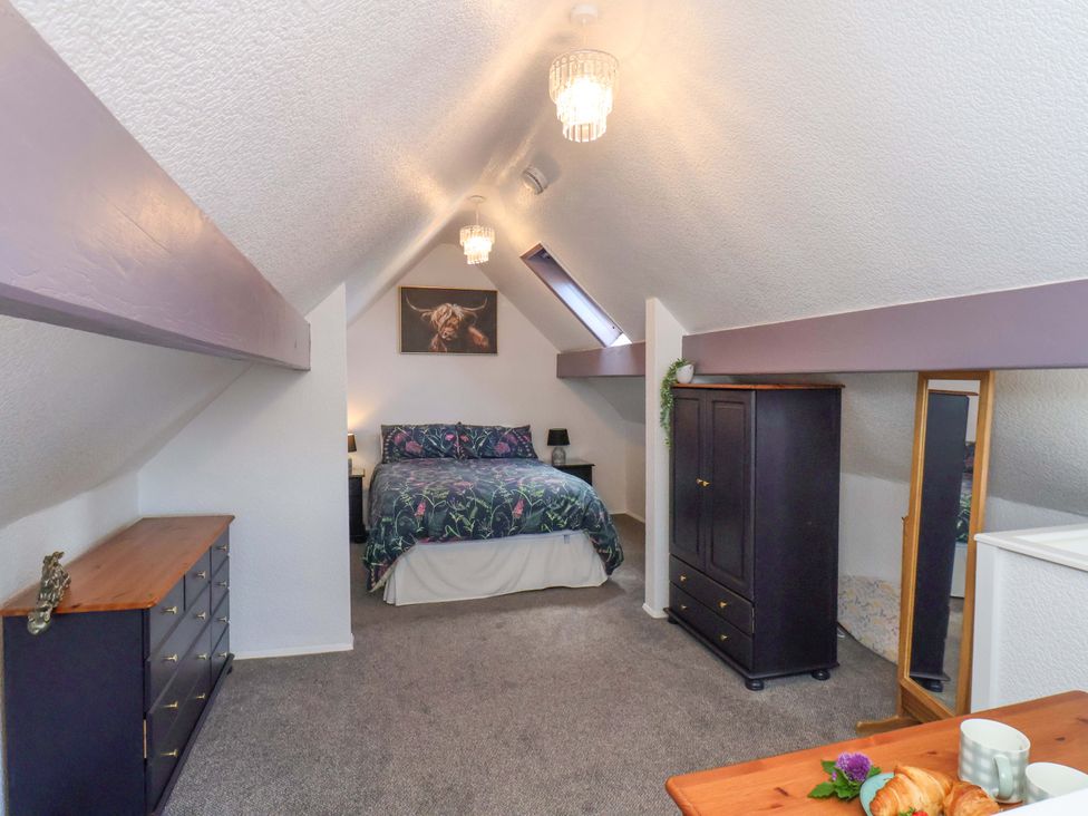 A bedroom with a bed and wardrobe at Wayside Farm Stable Cottage Cloughton near Burniston