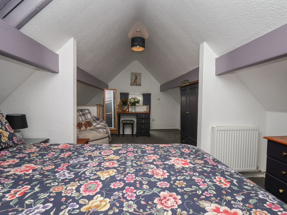 A bedroom with a bed and furniture at Wayside Farm Stable Cottage Cloughton near Burniston