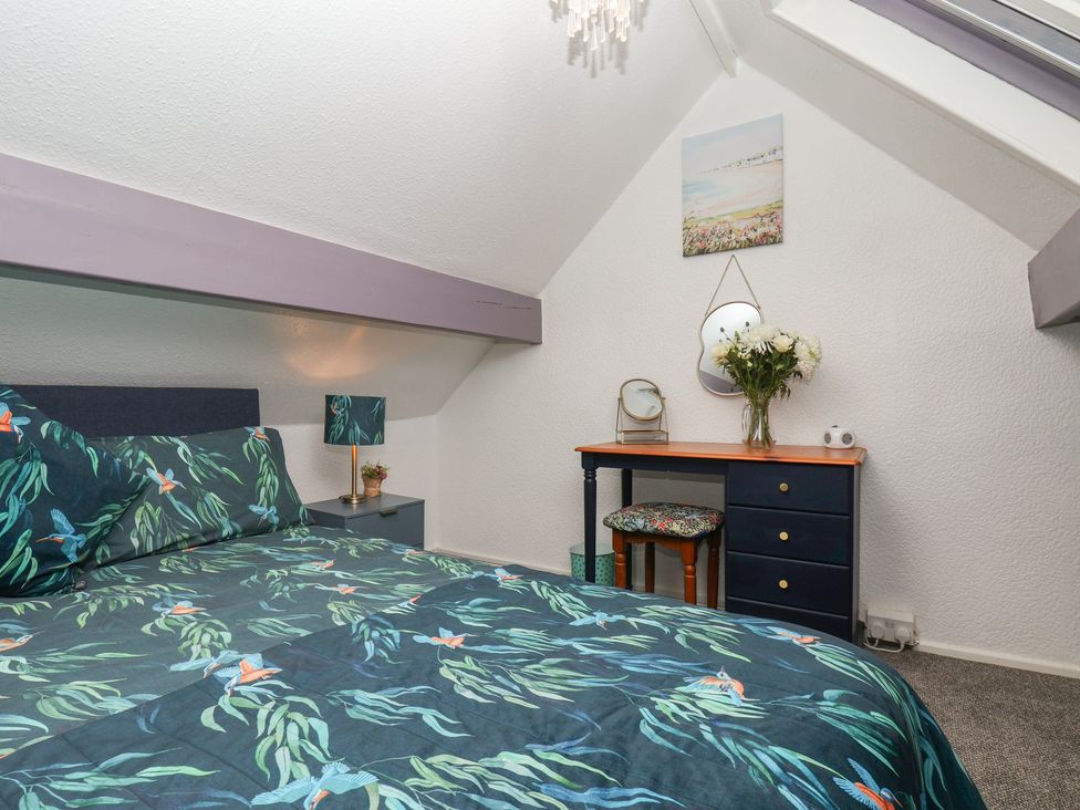 A bedroom with a bed and dresser at Wayside Farm Cart Cottage in Cloughton near Burniston