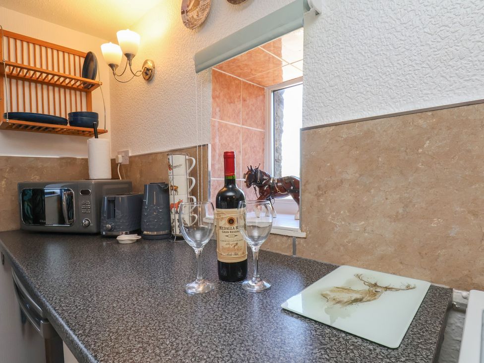 A kitchen with appliances and wine at Wayside Farm Cart Cottage Cloughton near Burniston