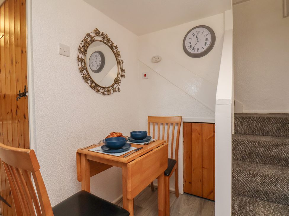 A dining area with a table and chairs at Wayside Farm Cart Cottage in Cloughton near Burniston