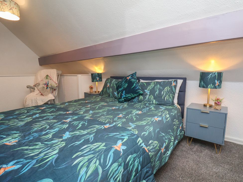 A bedroom with a bed and nightstand at Wayside Farm Cart Cottage Cloughton near Burniston