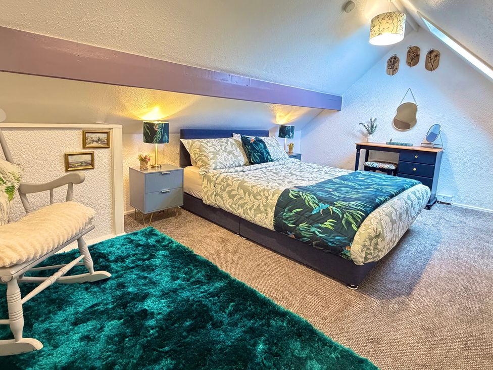 A bedroom with a bed and desk at Wayside Farm Cart Cottage Cloughton near Burniston