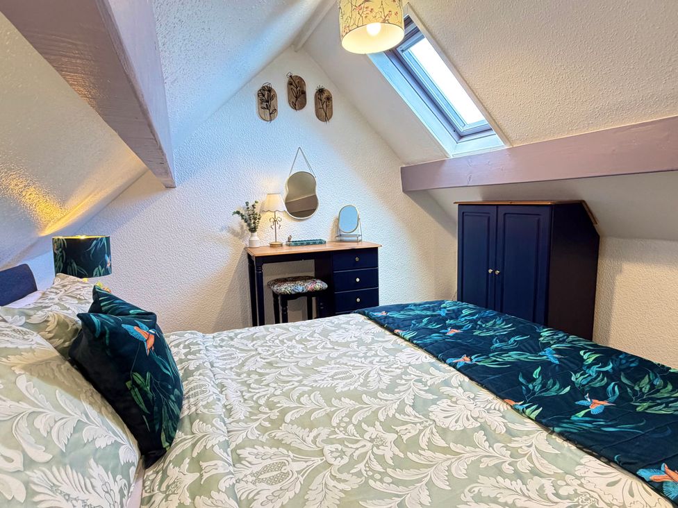 A bedroom with a bed and desk at Wayside Farm Cart Cottage Cloughton near Burniston