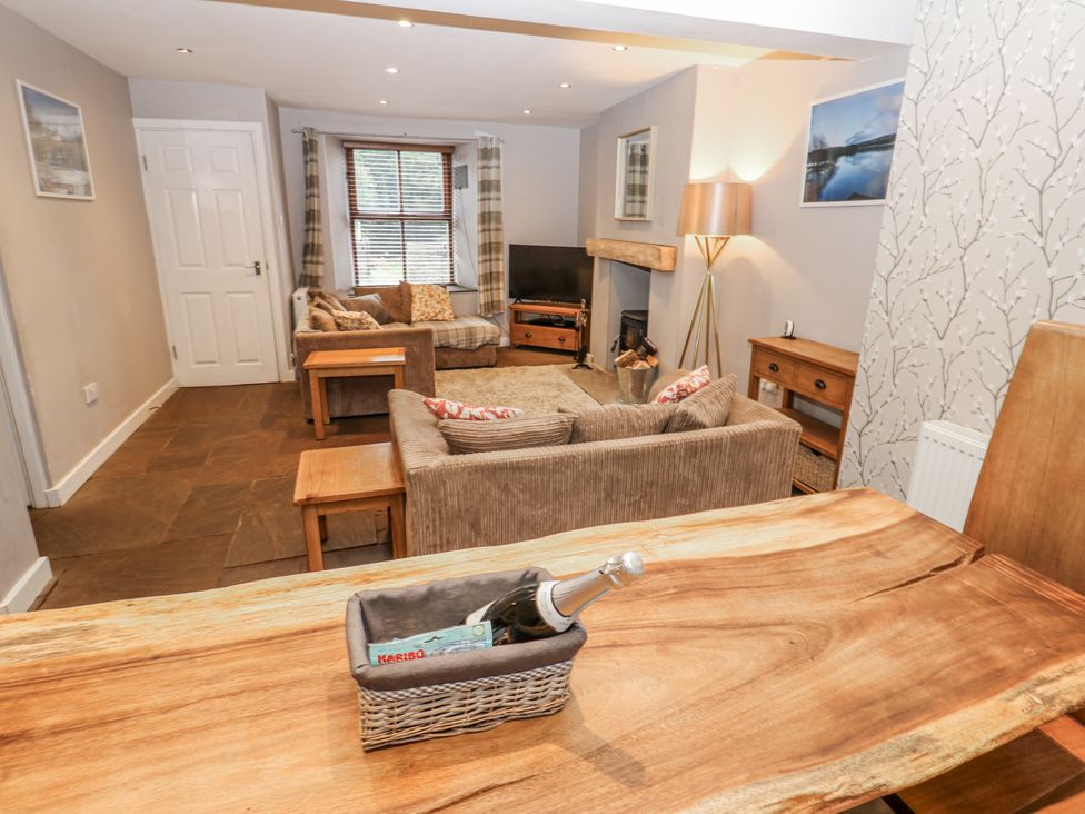 A living room with furniture and a television at Mill Race House in Alston