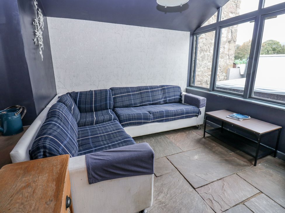 A living room with a sofa and a coffee table at Mill Race House in Alston