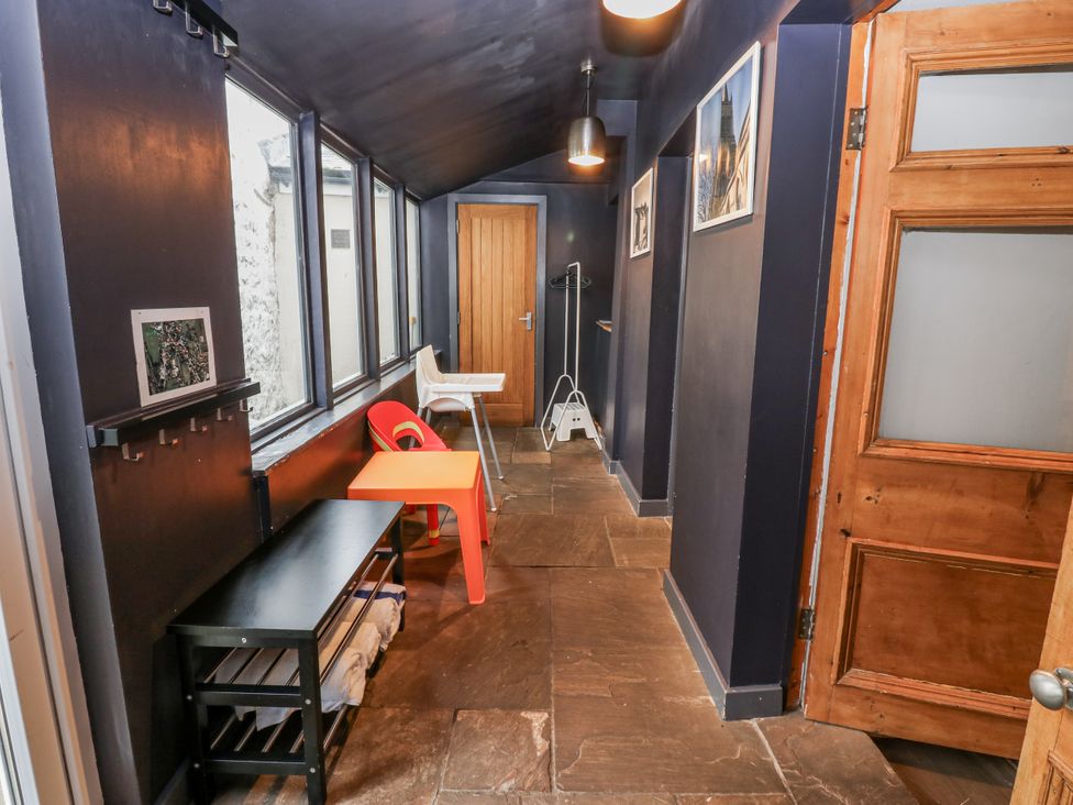 A hallway with a table and chair at Mill Race House Alston