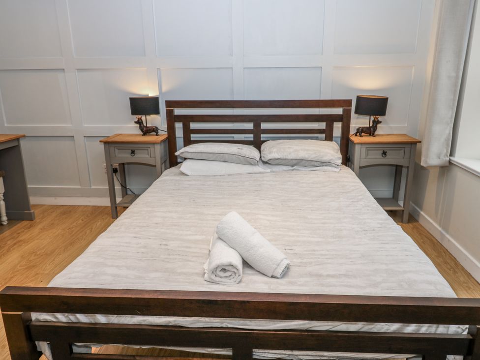 A bedroom with a bed and bedside tables at Mill Race House Alston