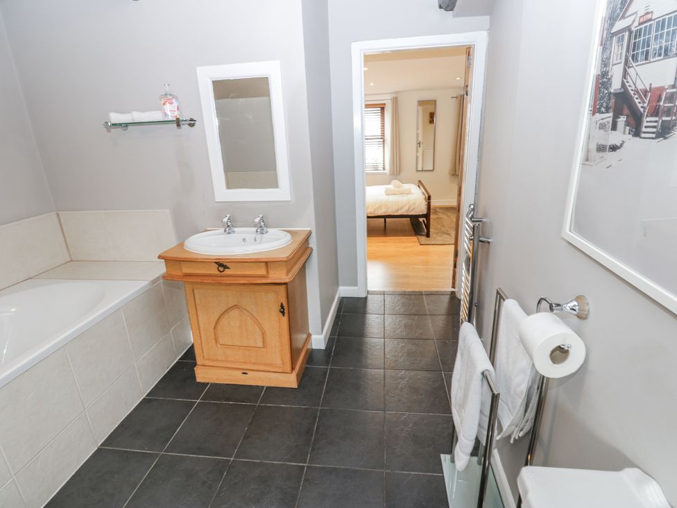 A bathroom with a sink and bathtub at Mill Race House in Alston
