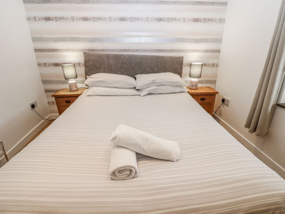 A bedroom with a bed and nightstand at Mill Race House in Alston