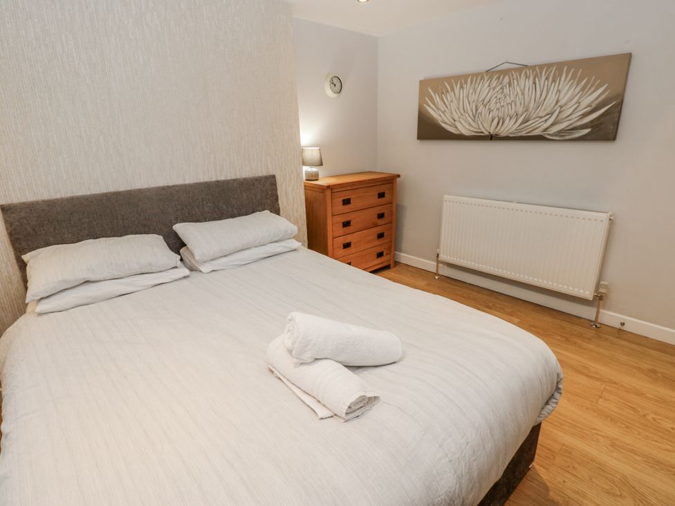 A bedroom with a bed and chest of drawers at Mill Race House in Alston