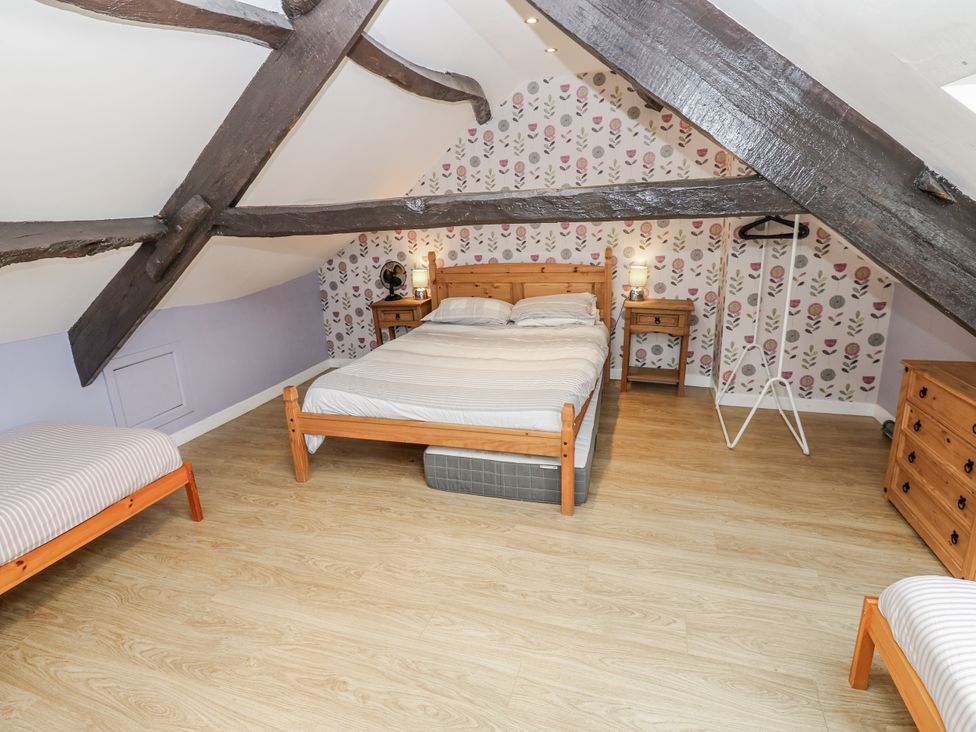 A bedroom with a bed and nightstands at Mill Race House in Alston
