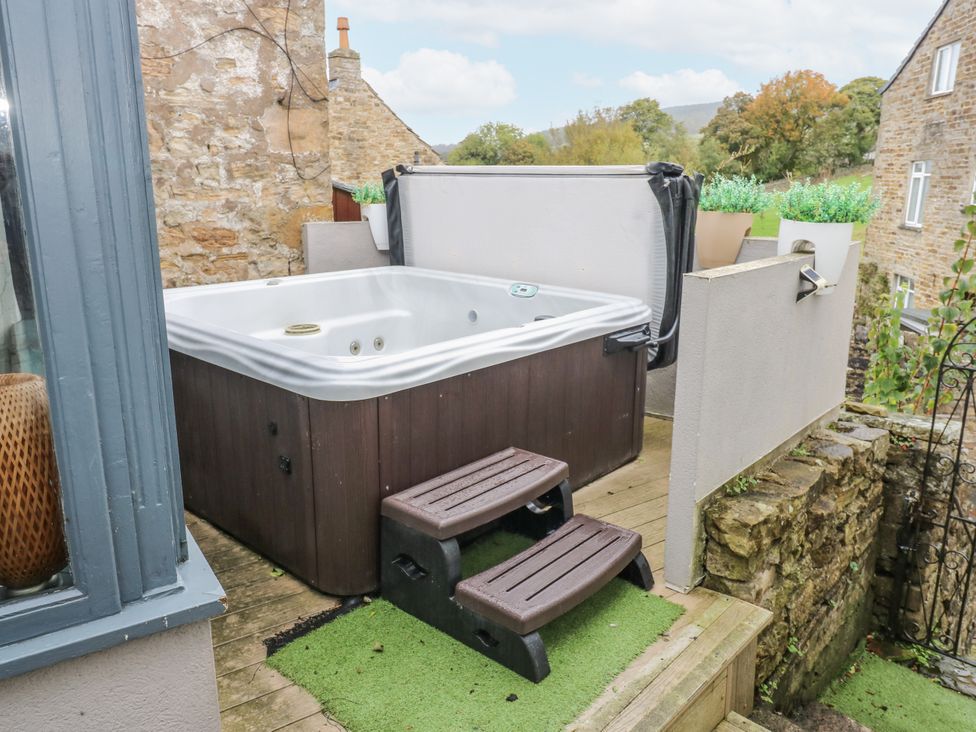 A hot tub with steps in an outdoor area at Mill Race House Alston