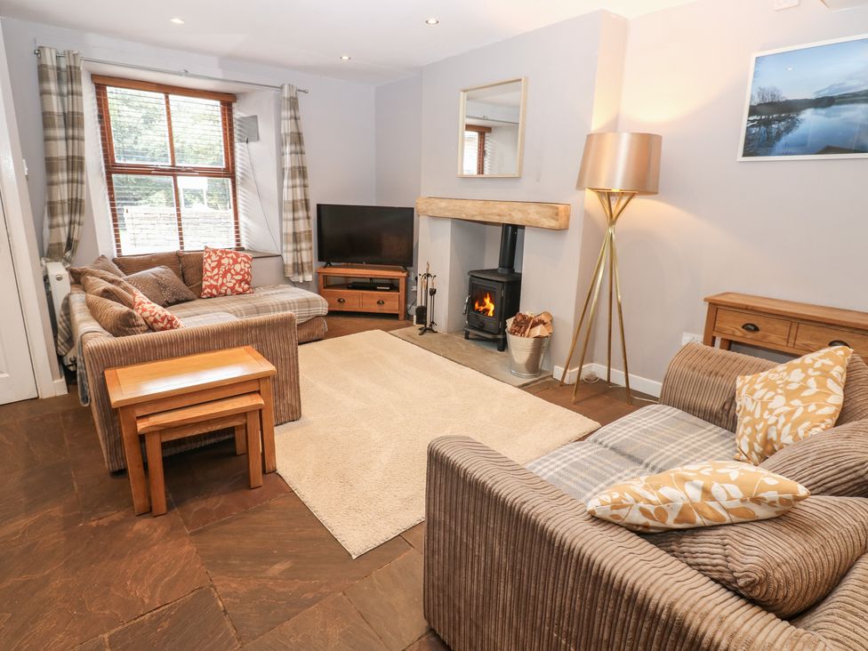 A living room with sofas and a television at Mill Race House Alston