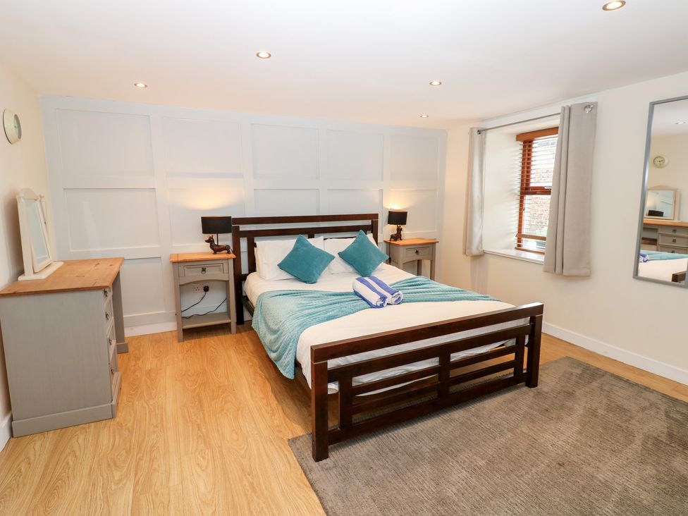 A bedroom with a bed and a dresser at Mill Race House Alston