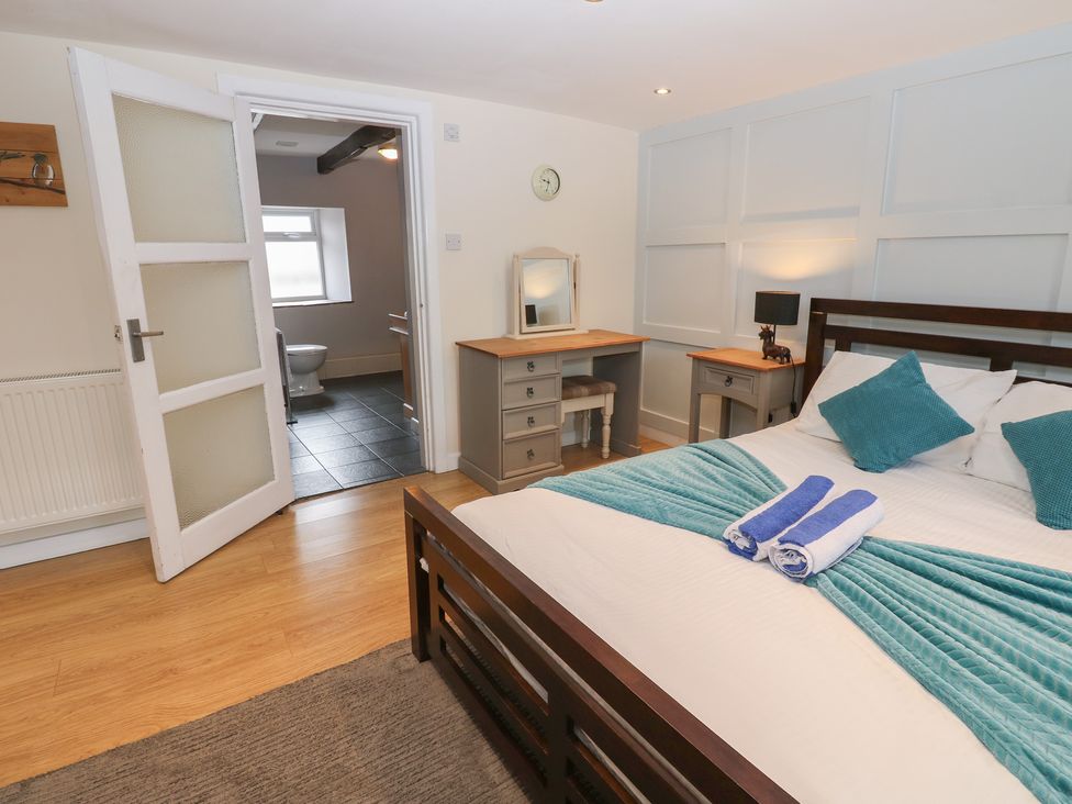 A bedroom with a bed and desk at Mill Race House in Alston
