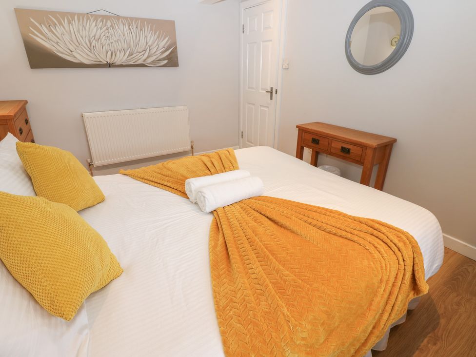 A bedroom with a bed and nightstand at Mill Race House in Alston
