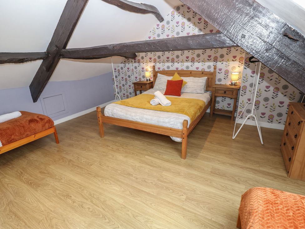 A bedroom with a bed and bedside tables at Mill Race House Alston