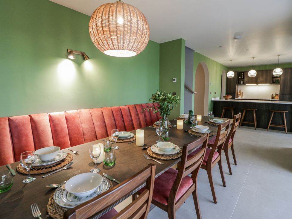 A dining room with a table set for a meal at Twyn Isaf in Borth