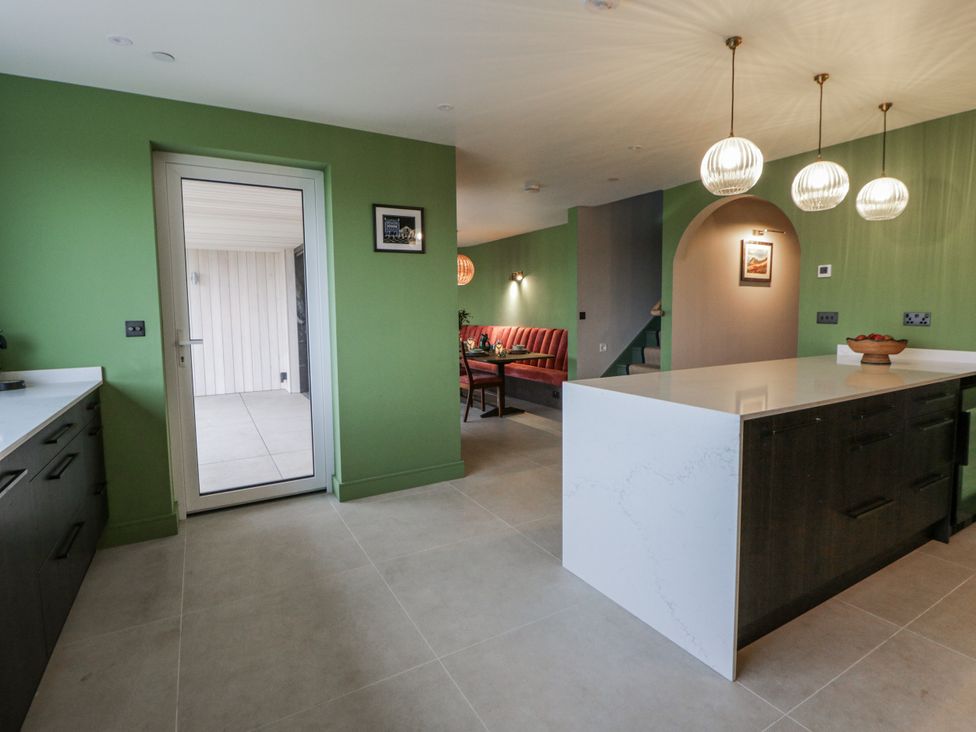 A kitchen with a door leading outside at Twyn Isaf in Borth
