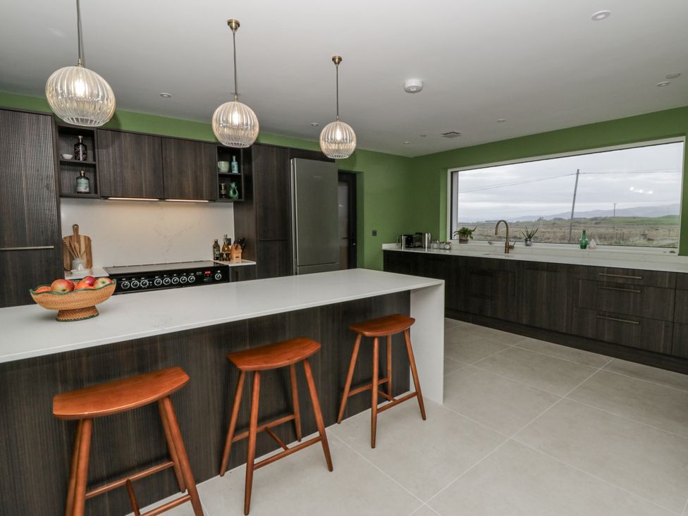 A kitchen with modern features and a view at Twyn Isaf in Borth