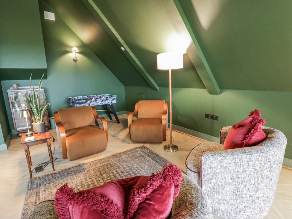 A snug with two armchairs and a lamp at Twyn Isaf in Borth