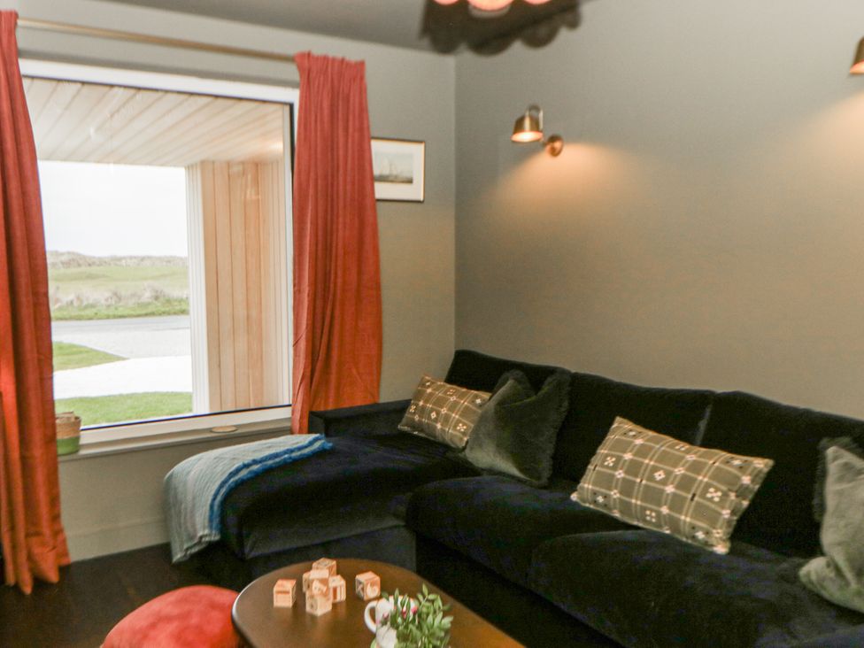 A living room with sofa and window at Twyn Isaf in Borth