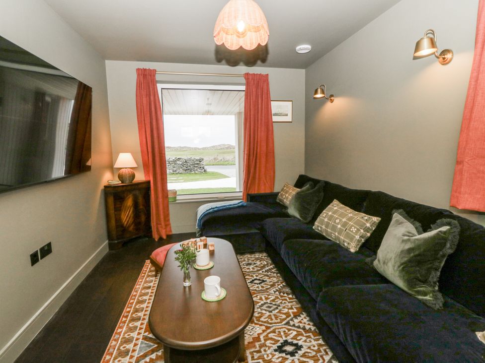 A living room with a sofa and television at Twyn Isaf in Borth