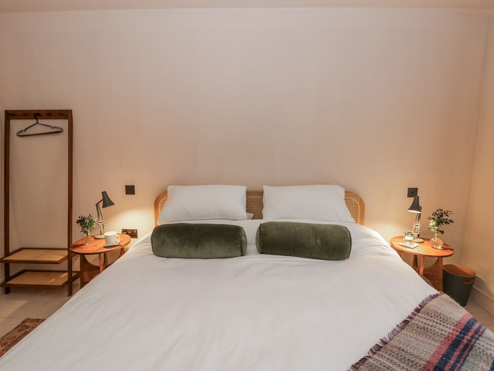A bedroom with a bed and bedside tables at Twyn Isaf in Borth