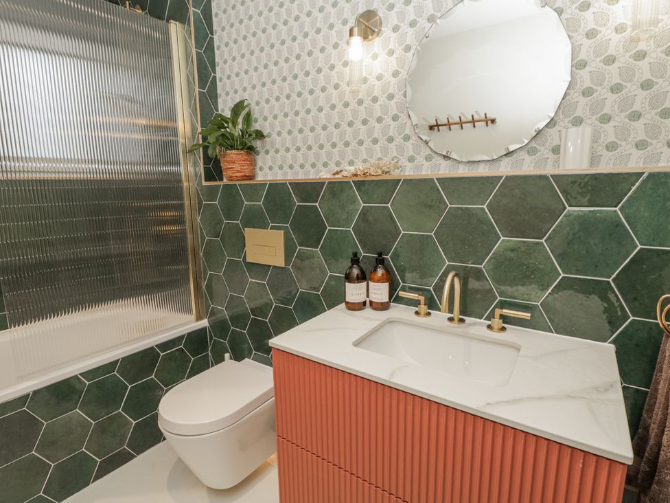 A bathroom with a sink and mirror at Twyn Isaf in Borth