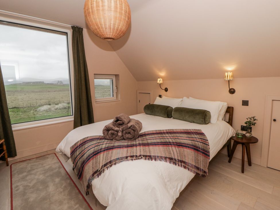 A bedroom with a bed and window at Twyn Isaf in Borth