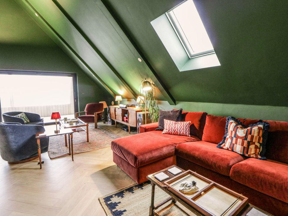 A living room with a sofa and coffee table at Twyn Isaf in Borth