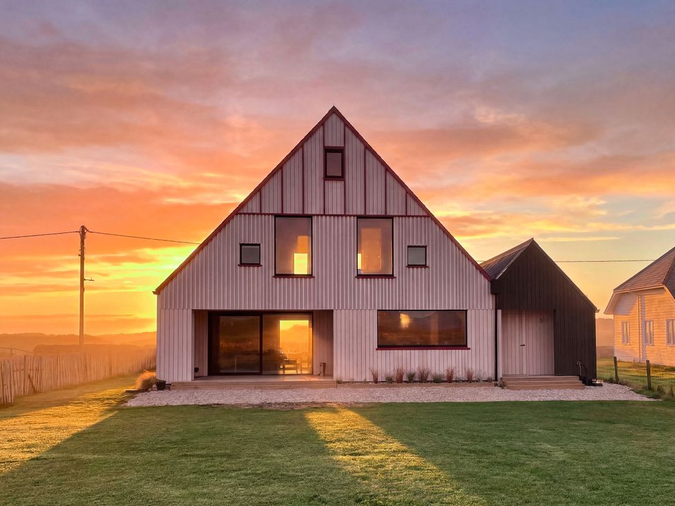 A house with large windows and a door at Twyn Isaf in Borth