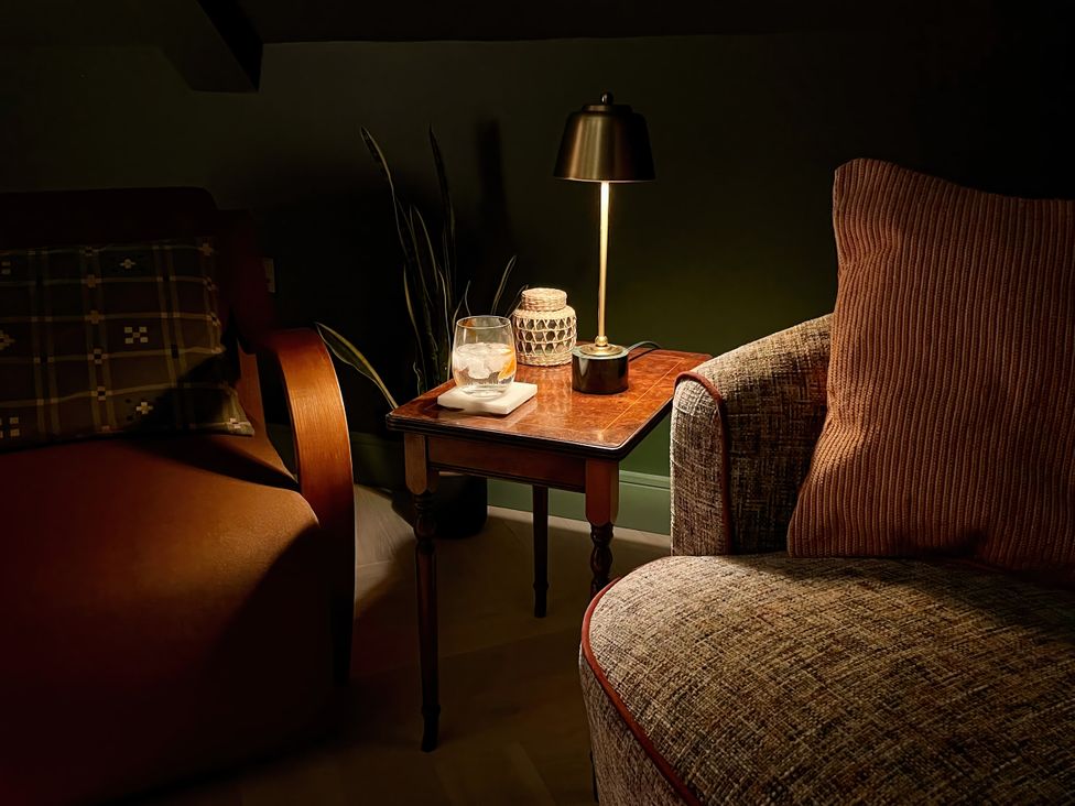 A living room with a table and lamp at Twyn Isaf Borth