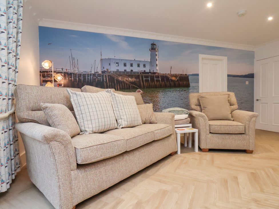 A living room with a sofa and armchair at 32 Quay Street in Scarborough