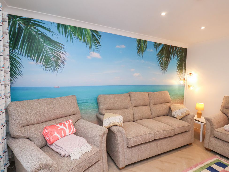 A living room with a wall mural and two sofas at 32 Quay Street in Scarborough