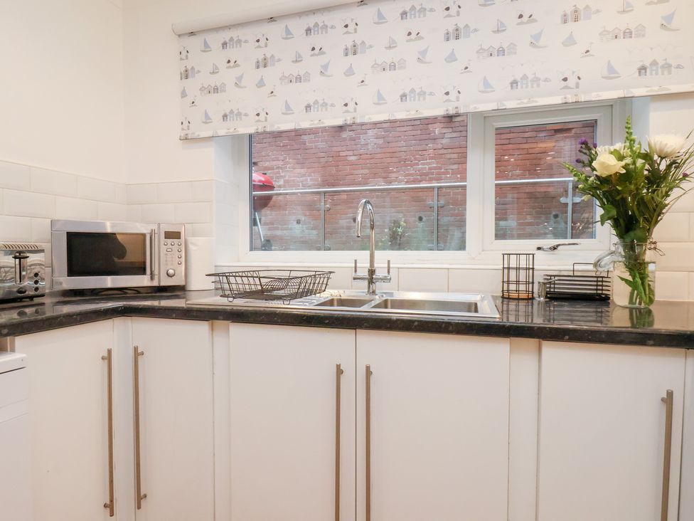 A kitchen with a sink and microwave at 32 Quay Street, Scarborough