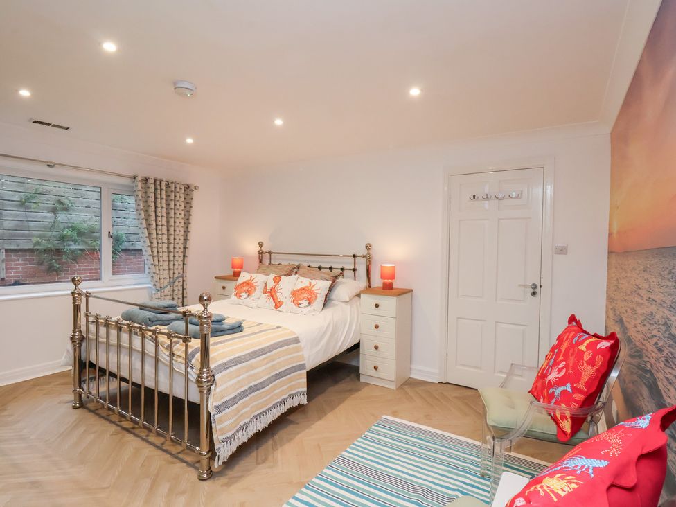 A bedroom with a bed and nightstand at 32 Quay Street in Scarborough