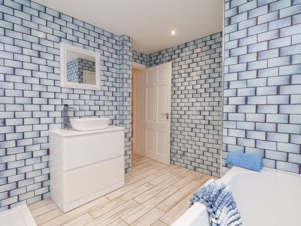 A bathroom with sink and bathtub at 32 Quay Street Scarborough