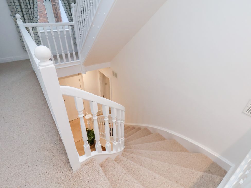 A staircase with a railing and a door at 32 Quay Street Scarborough