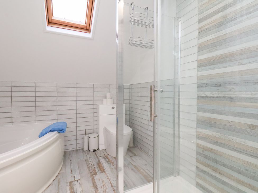 A bathroom featuring a bath tub and shower at 32 Quay Street Scarborough