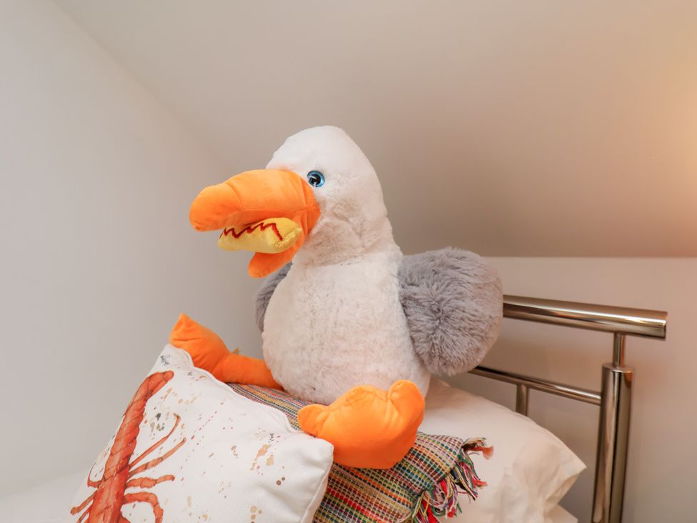 A plush toy of a bird on a bed at 32 Quay Street in Scarborough