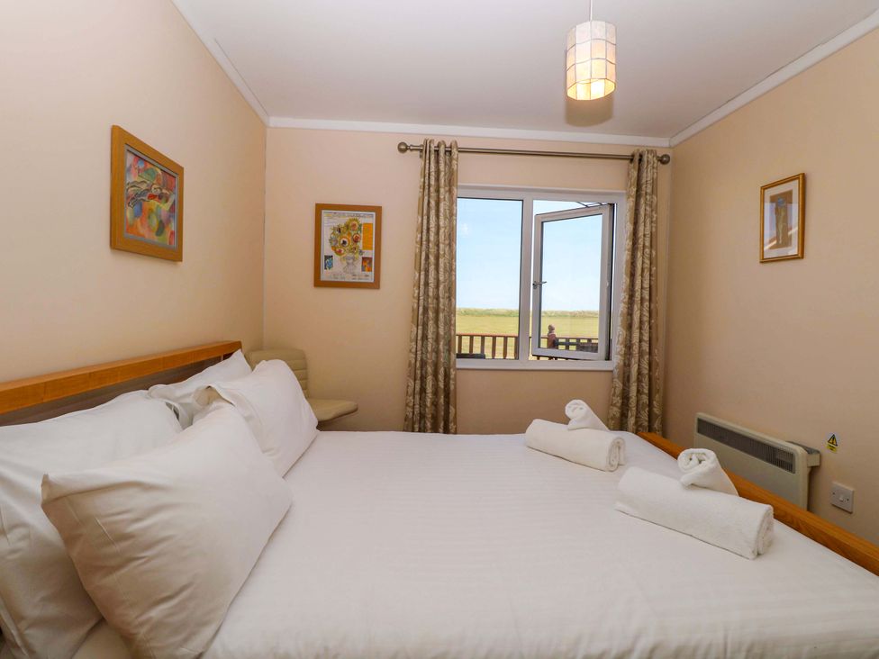 A bedroom with a bed and window at Boa Vista in Bacton