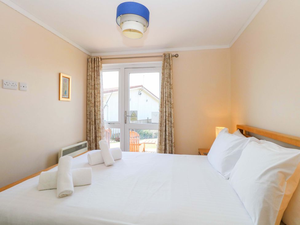 A bedroom with a bed and curtains at Boa Vista in Bacton