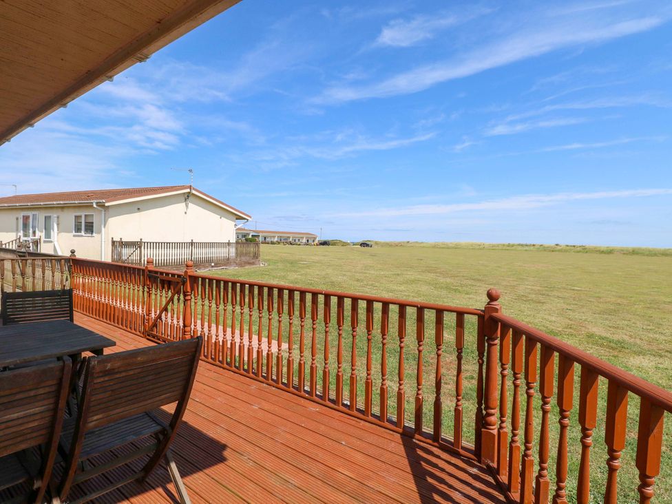 An outdoor area with decking and furniture at Boa Vista in Bacton