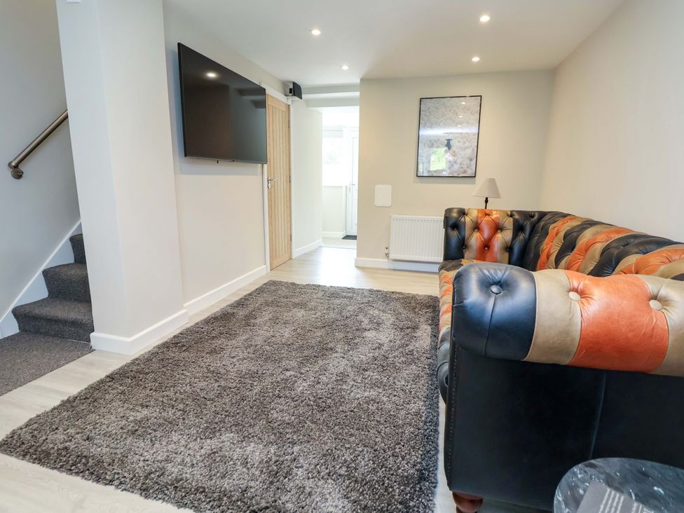 A living room with a sofa and television at Cartref Pen Y Ball near Holywell