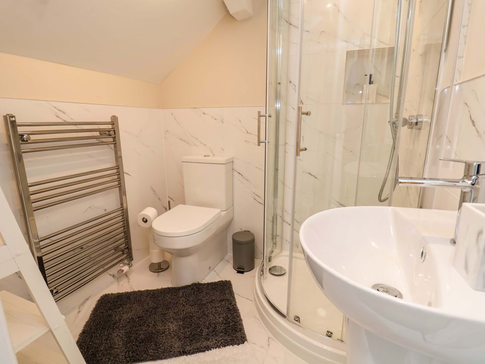 A bathroom with shower, sink and toilet at Cartref Pen Y Ball near Holywell