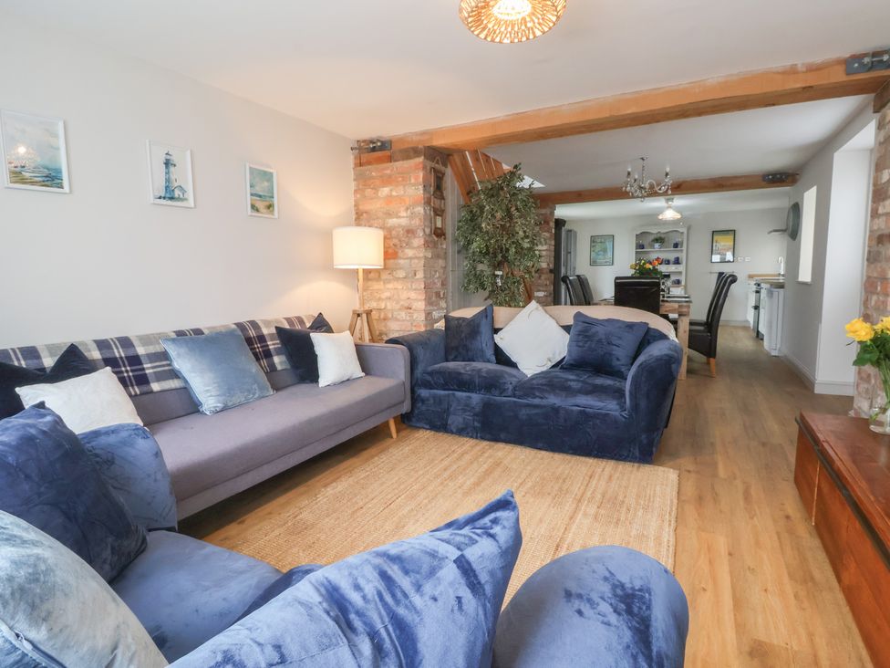 A living room with sofas and a dining area in The Old Vicarage Annex Hornsea